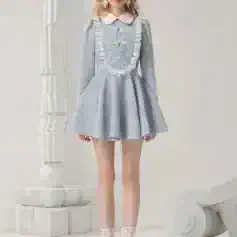 Elegant pastel blue tea dress with lace detailing, puff sleeves, and white collar, perfect for stylish occasions and fashion-forward events.