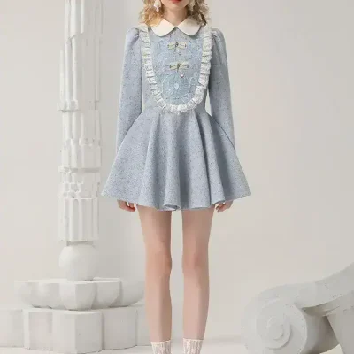 Elegant pastel blue tea dress with lace detailing, puff sleeves, and white collar, perfect for stylish occasions and fashion-forward events.