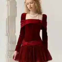 Luxurious red velvet dress with off-shoulder design, fitted waist, and layered tulle skirt, perfect for elegant events and fashion-forward occasions.