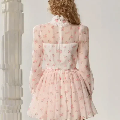 Floral pink and white dress with sheer long sleeves, pleated skirt, and back zipper for stylish and elegant look. Perfect for spring or summer occasions, combining comfort with fashion.