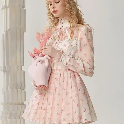 Pink floral dress with long sleeves and high collar, elegant and feminine fashion for women, suitable for special occasions or casual wear.