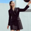 Elegant woman in black blazer dress with glasses, modern fashion style, outdoor urban background, suitable for professional and casual wear, Monalisa Store optical fashion.