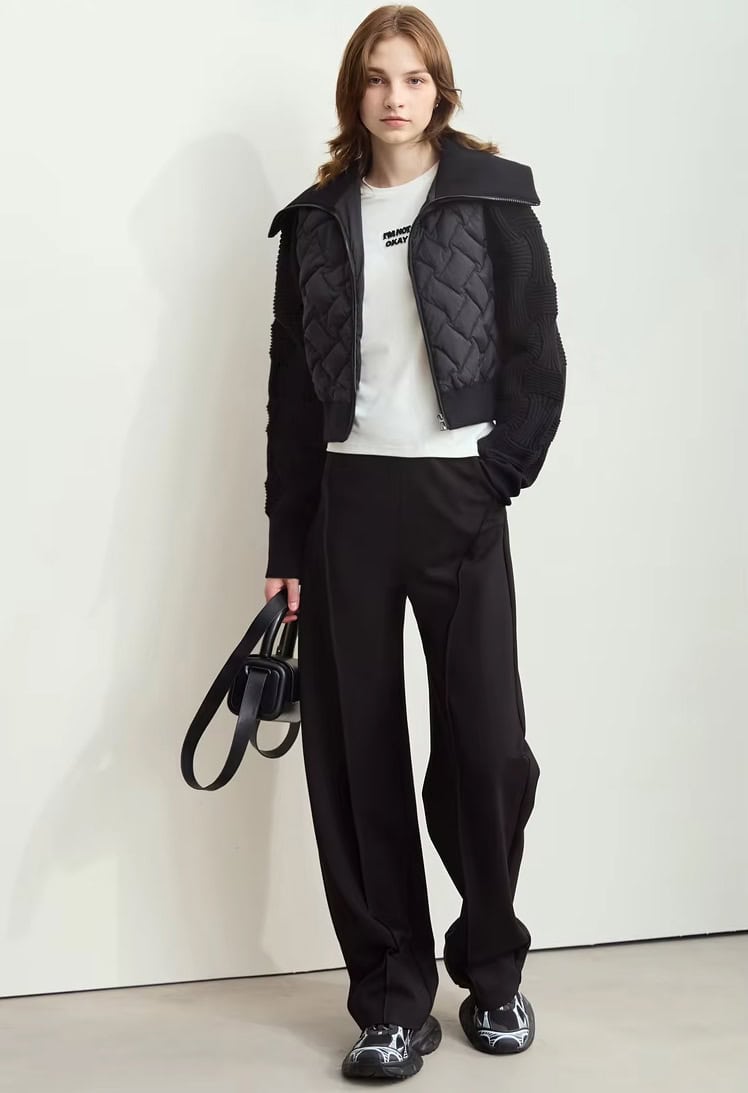Stylish young woman in Monalisa Store sportswear, layered winter jacket, casual white t-shirt, black tailored pants, and sneakers, showcasing fashionable and comfortable clothing options.