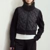 Stylish black quilted and knit bomber jacket for women, perfect for cold weather and casual fashion, featuring a high collar, zip closure, and comfortable fit.