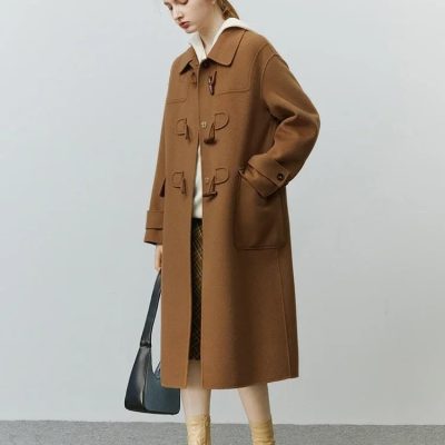 Elegant women's brown coat with toggle buttons, stylish boots, and a black handbag, perfect for fall and winter fashion. Monalisa Store offers high-quality outerwear and accessories for sophisticated looks.