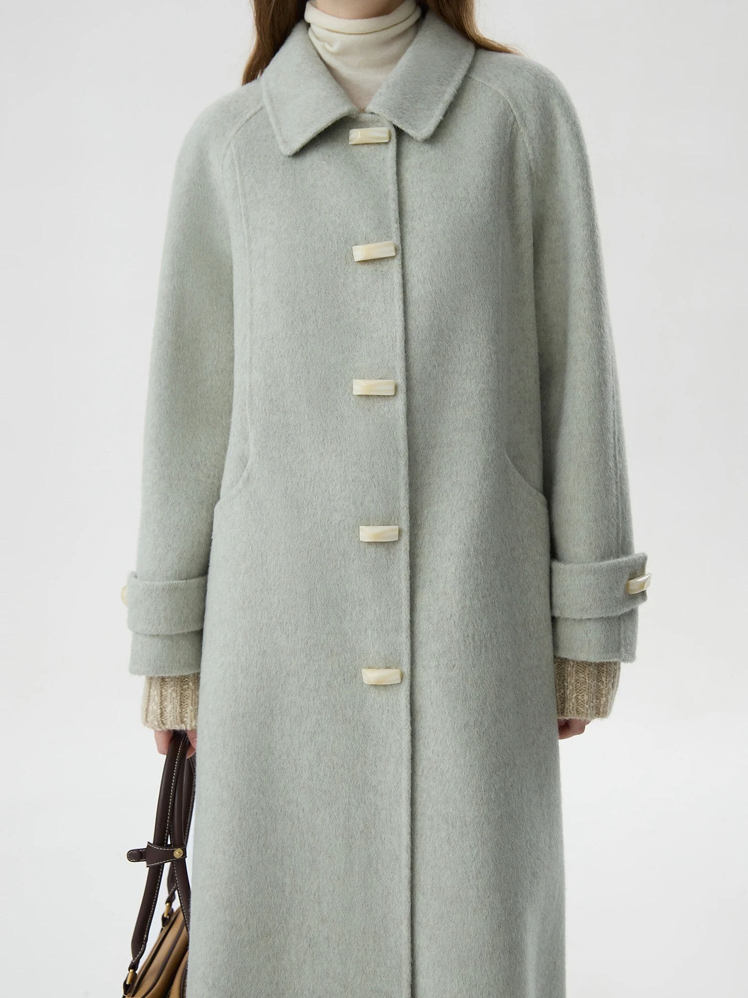 Luxurious light gray wool coat with toggle buttons, perfect for winter fashion, available at Monalisa Store for stylish and cozy cold weather wear.