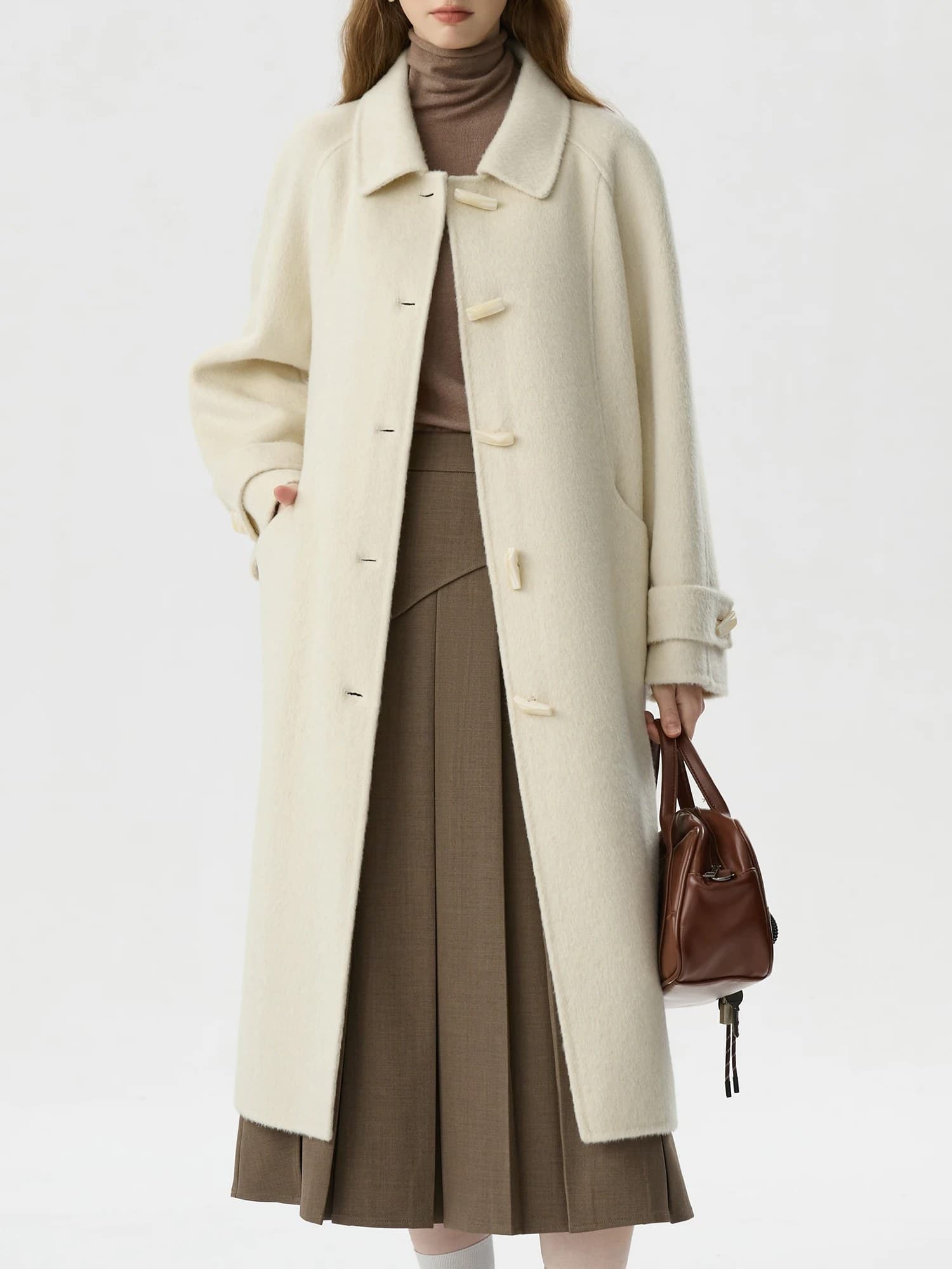 Luxurious cream wool coat with large collar and toggle buttons, perfect for fall and winter fashion. Model showcases elegant outerwear for women, combining warmth and style at Monalisa Store.
