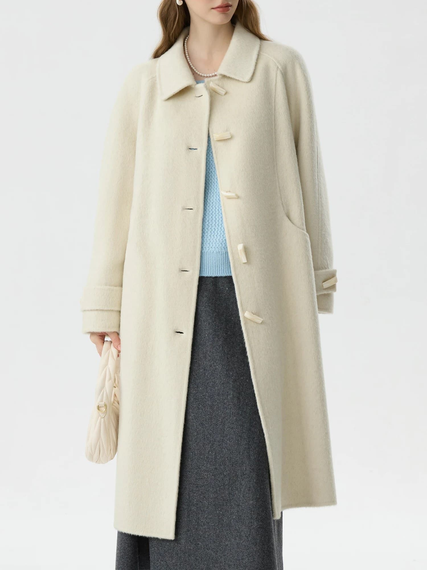 Luxurious cream-colored wool coat with classic design, oversized fit, and elegant button details, perfect for winter fashion at Monalisa Store.