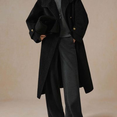 Luxurious black wool winter coat showcased at Monalisa Store, paired with stylish wide-leg trousers and a sleek handbag, perfect for elegant, fashionable winter outfits.