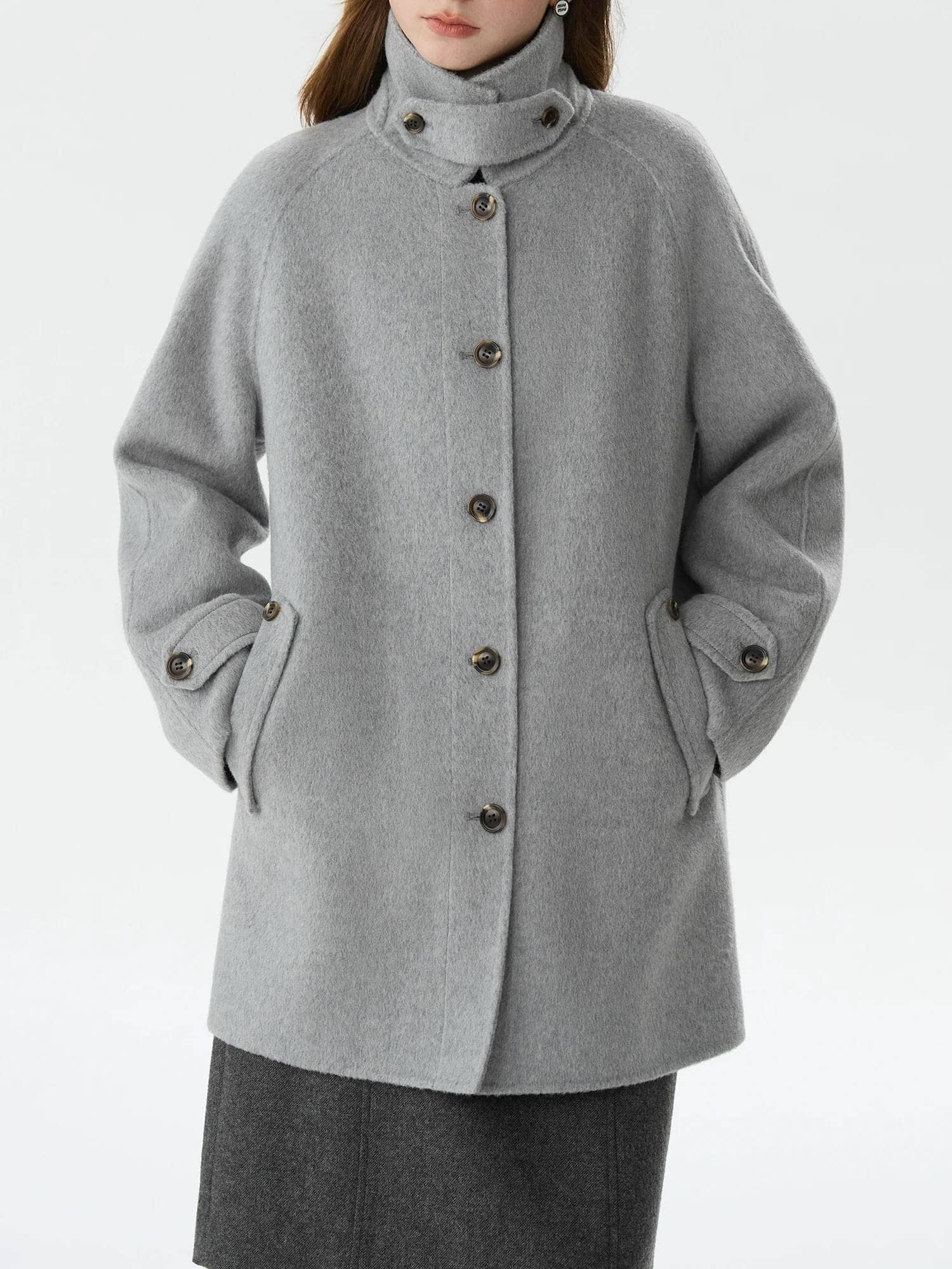 Luxurious grey wool coat with button closures, tailored design, and cozy high collar, perfect for stylish warmth and fall or winter outerwear. Ideal for fashion-forward women seeking elegant coats.