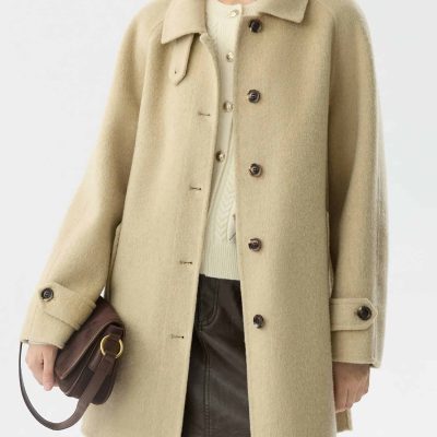 Beige wool coat hanging on a model, ideal for stylish winter fashion.
