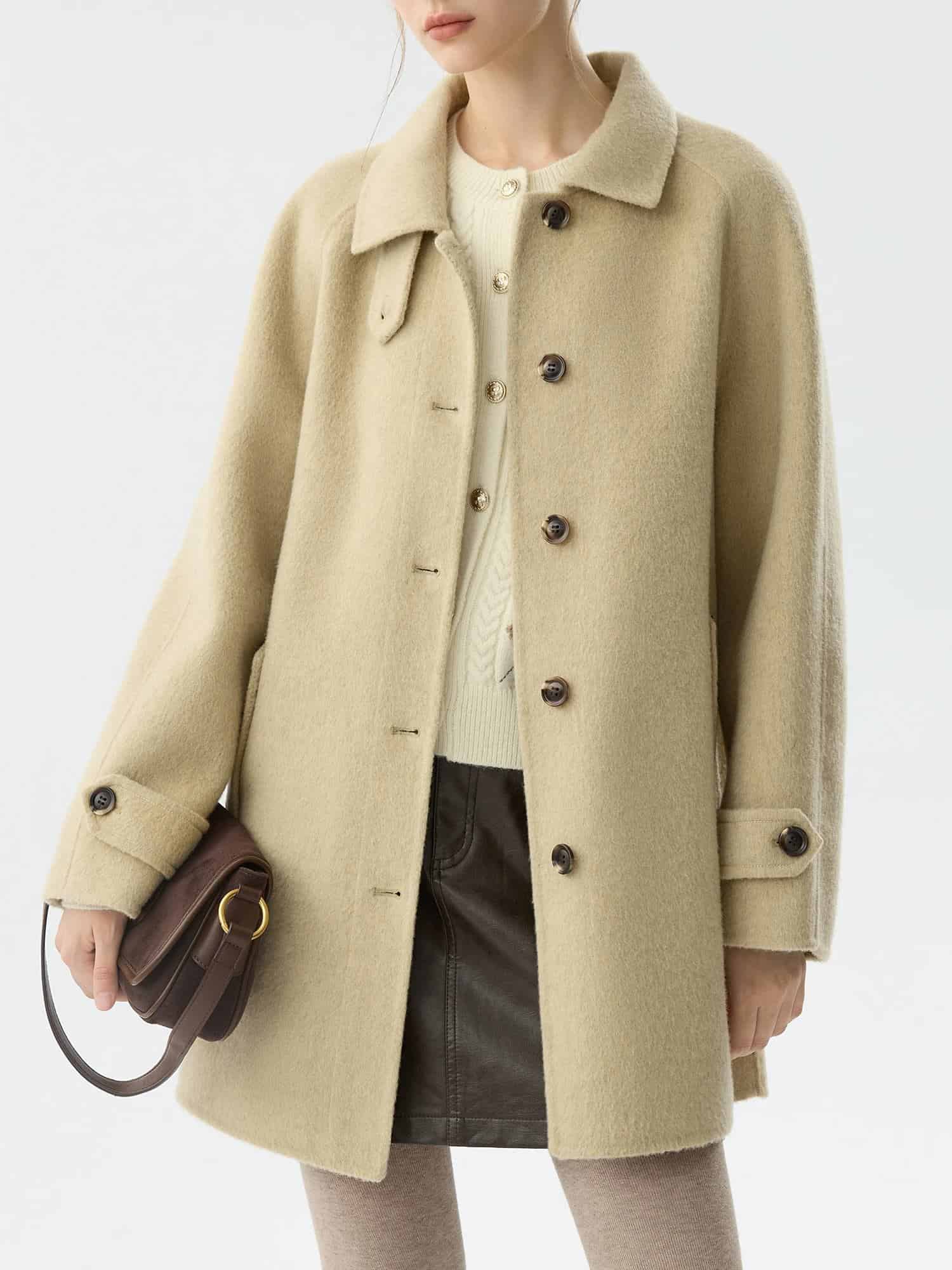 Beige wool coat hanging on a model, ideal for stylish winter fashion.