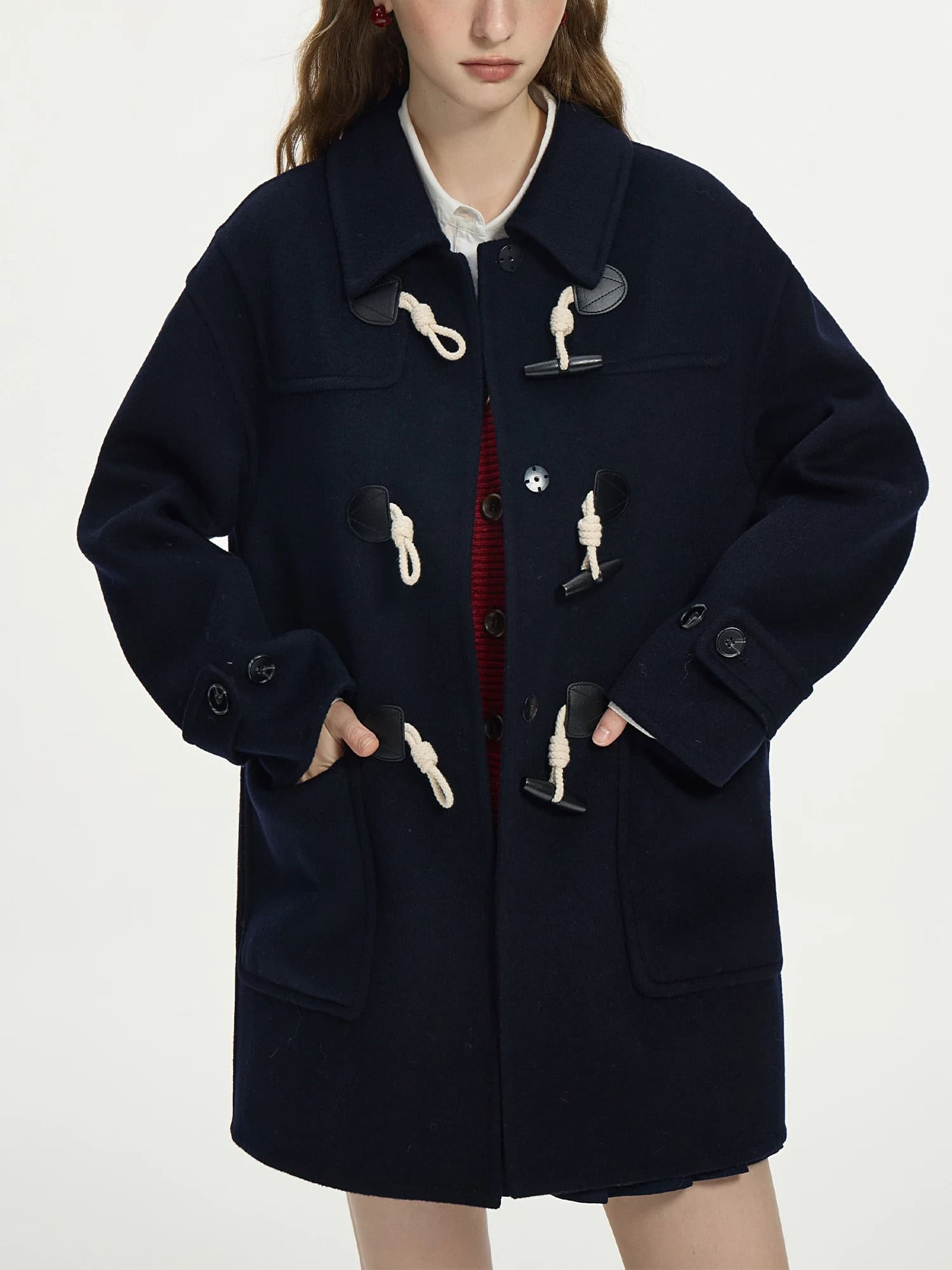 Warm navy duffle coat with toggle closures, perfect for winter fashion and casual wear.