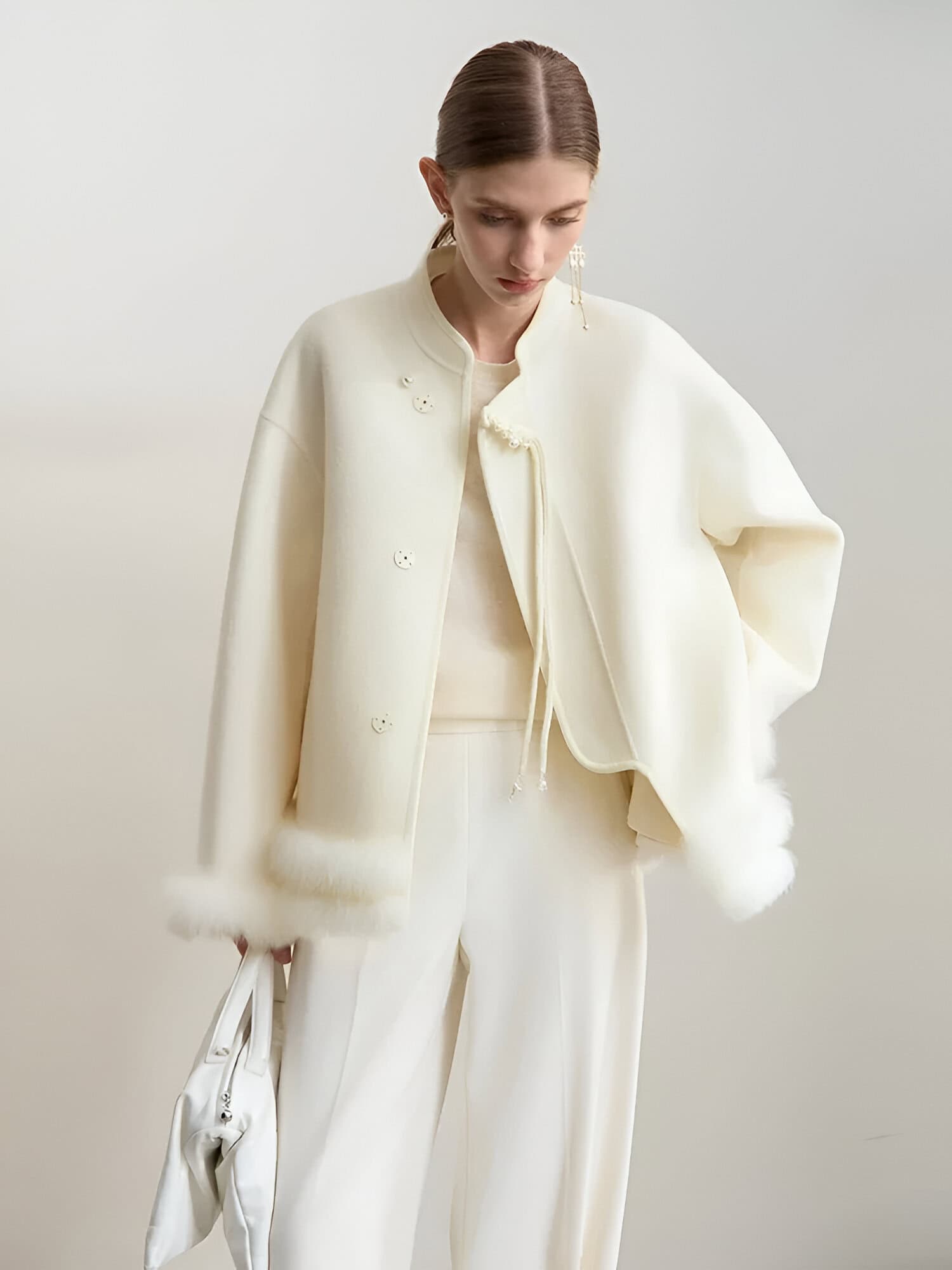 Elegant white fashion outfit featuring a luxurious fur-trimmed jacket and matching wide-leg pants, perfect for stylish and sophisticated look at Monalisa Store, ideal for modern fashion enthusiasts.