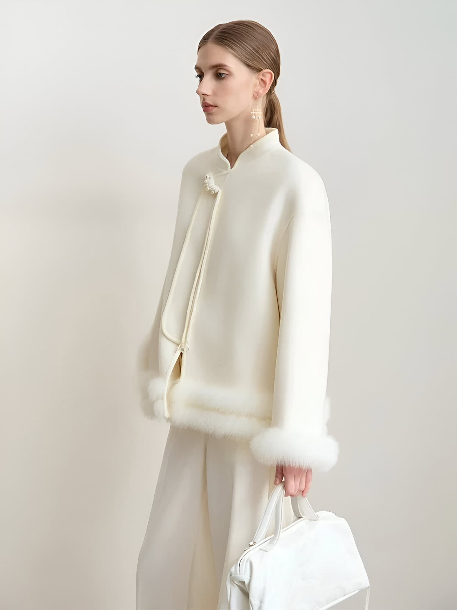 Elegant white jacket with fur trim, designed for luxurious fashion and style. Perfect for sophistication, featuring high-quality fabric and refined details. Ideal for upscale fashion enthusiasts.