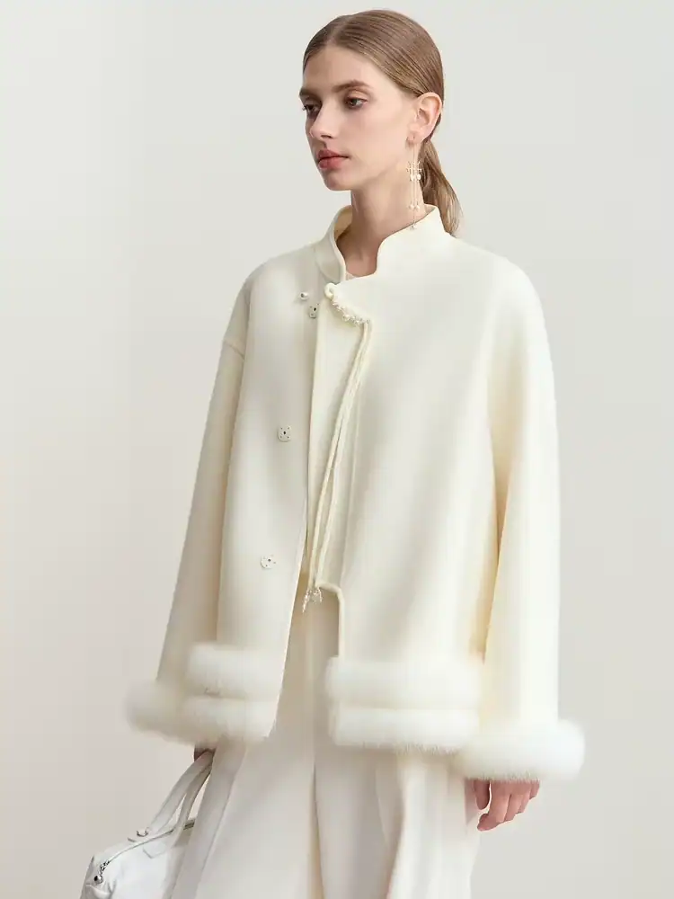 Luxurious white fur-trimmed coat showcasing high-end fashion and elegance, perfect for winter wear.