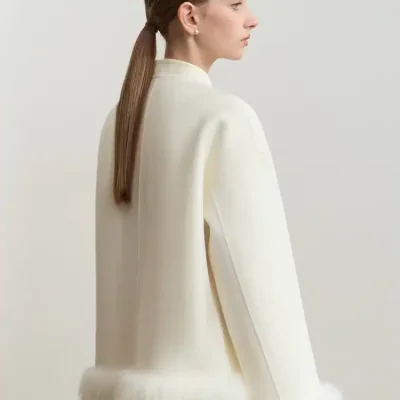 Luxurious white cashmere coat with faux fur trim, elegant and cozy fashion piece for winter, perfect for sophisticated women seeking high-quality outerwear.
