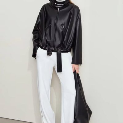 Black faux leather jacket with zipper details and tie waist, paired with white wide-leg pants and stylish accessories, showcasing fashionable women's clothing at Monalisa Store.