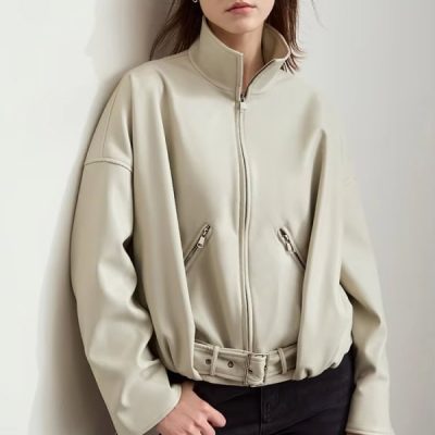Soft beige faux leather bomber jacket with zippered pockets and adjustable waist, stylish women's outerwear perfect for fall and winter.