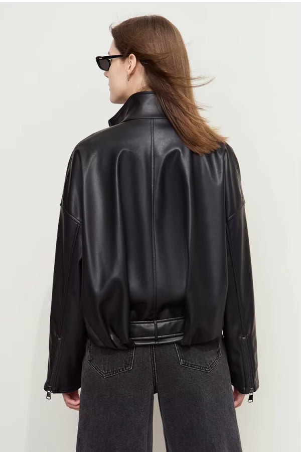 Black faux leather bomber jacket for women, stylish and trendy outerwear, perfect for casual and streetwear fashion. Comes with zippered cuffs and a sleek, modern design.