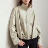 A beige oversized zip-up jacket with a high collar and waist belt, showcasing stylish casual wear options from Monalisa Store.