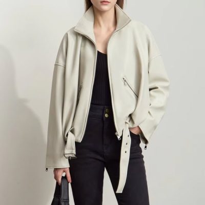 Stylish cream-colored women's leather jacket with zippered pockets, perfect for fall and winter fashion. Trendy and comfortable, ideal for a chic, casual look.
