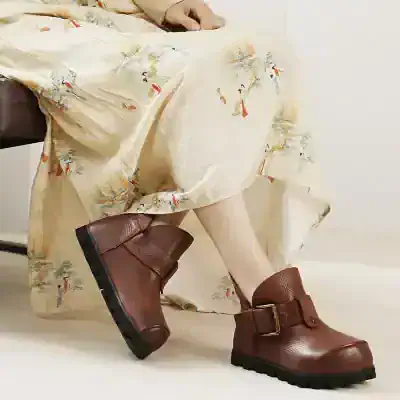 Comfortable leather boots with buckle detail for women’s fashion and style.
