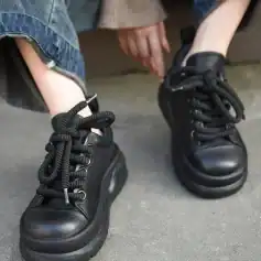 Soft leather black chunky platform sneakers for women, trendy fashion footwear with thick soles and lace-up design.