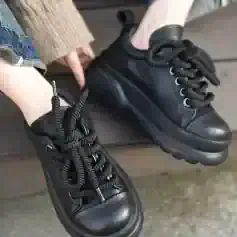 Comfortable black leather casual sneakers with chunky soles and stylish lacing, perfect for everyday wear and outdoor activities. Ideal for fashion-forward individuals seeking versatile footwear.