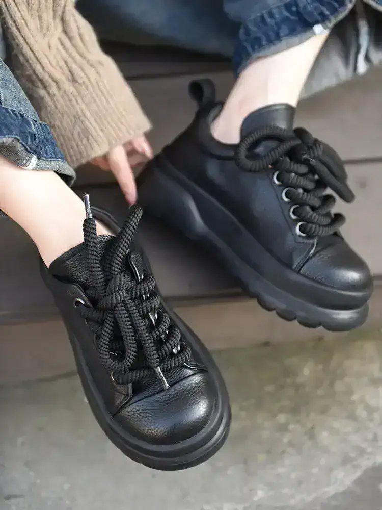 Comfortable black leather casual sneakers with chunky soles and stylish lacing, perfect for everyday wear and outdoor activities. Ideal for fashion-forward individuals seeking versatile footwear.
