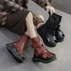 Unique fashion-forward combat boots with chunky soles and adjustable straps, available in stylish black and brown, perfect for modern streetwear and everyday wear.