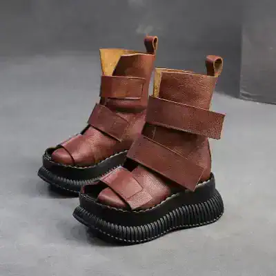 Leather chunky platform boots with wide straps and open toes, stylish footwear for fashion-forward individuals. Perfect for trendy outfits and bold fashion statements.