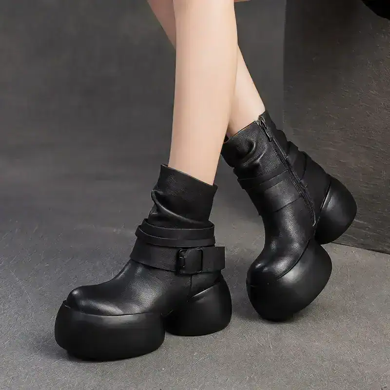 Platform boots with chunky, spherical soles, black faux leather, stylish and modern, perfect for fashion-forward outfits, featured on Monalisa Medical store website, trendy footwear for women.