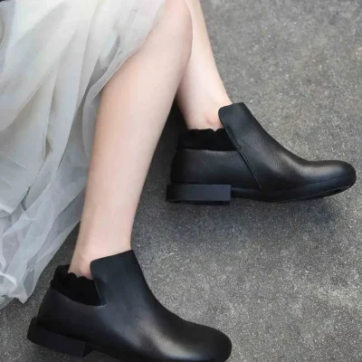 Stylish black ankle boots with comfortable block heels, suitable for fashionable women seeking versatile footwear for daily or special occasions. Perfect for modern, chic outfits.