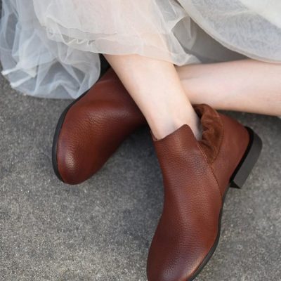 Brown leather ankle boots with a textured finish and low heel for women.
