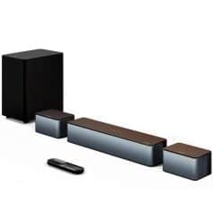 Wireless home theater sound system with sleek black and silver speakers and remote control for immersive audio experience.