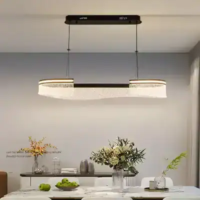 Modern LED pendant light fixture hanging above a stylish dining table with floral centerpiece in a contemporary home interior.