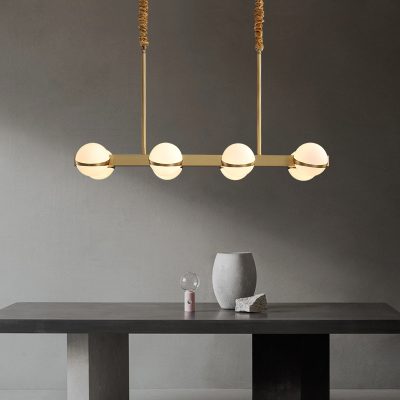Modern minimalist ceiling light fixture with four spherical glass bulbs in gold finish for contemporary interior decor.