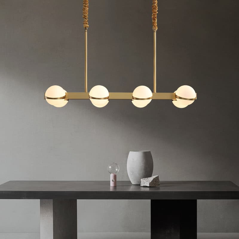Modern minimalist ceiling light fixture with four spherical glass bulbs in gold finish for contemporary interior decor.