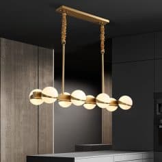 Modern gold and white pendant chandelier with spherical glass shades hanging in a contemporary kitchen.