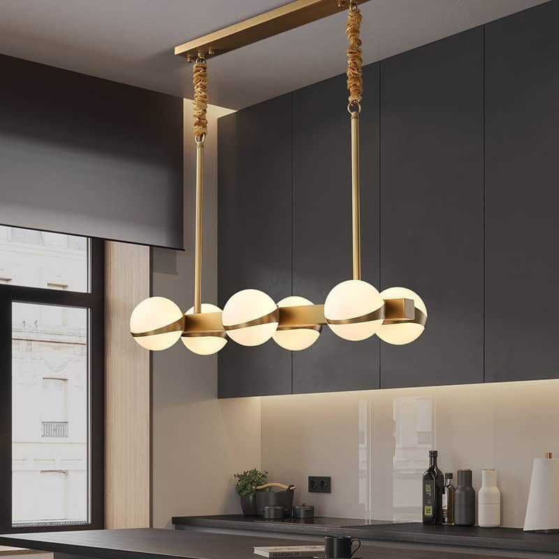 Modern stylish pendant light fixture with globe design hanging above kitchen counter at Monalisa Store for premium lighting solutions.