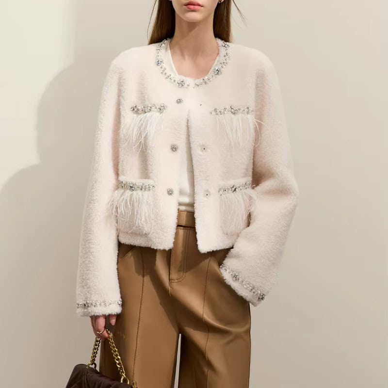 Luxurious white embellished fur cardigan with crystal accents, perfect for elegant fashion statements.