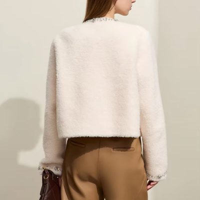 Elegant women's fashion featuring a soft white textured sweater and tan tailored shorts, perfect for stylish and comfortable casual wear, showcased at Monalisa Store.