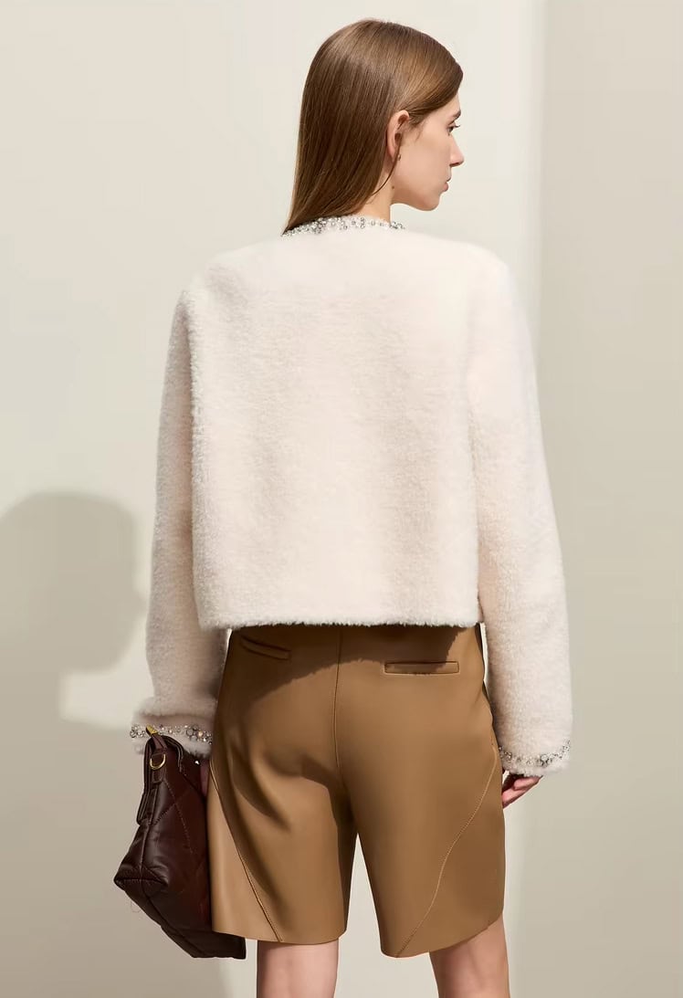 Elegant women's fashion featuring a soft white textured sweater and tan tailored shorts, perfect for stylish and comfortable casual wear, showcased at Monalisa Store.