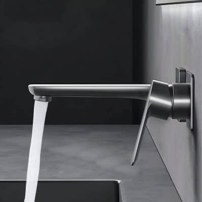 Polished modern stainless steel faucet in a sleek bathroom sink, with water flowing, emphasizing contemporary bathroom fixtures and high-quality plumbing accessories.