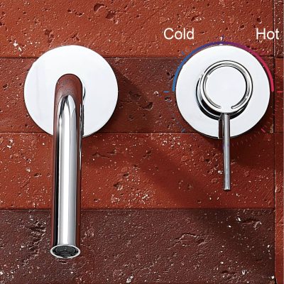 Brushed stainless steel sink faucet with temperature control knob on a textured red brick wall, modern kitchen fixture, sleek design, easy to operate hot and cold water, high-quality material for durability.
