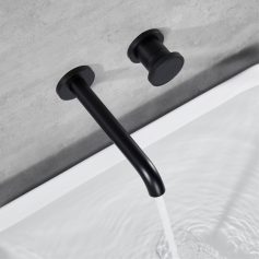 Sleek black wall-mounted faucet and control knob for bathroom sink, modern minimalist design for stylish and functional bathroom decor.