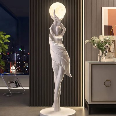 Elegant white sculpture of a female figure holding the moon, displayed inside Monalisa Medical Store, surrounded by modern decor and floral arrangements.