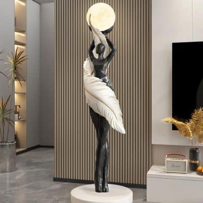 Elegant statue of a woman holding the moon with artistic feather details, perfect for modern interior decor and enhancing aesthetic appeal in luxury spaces.