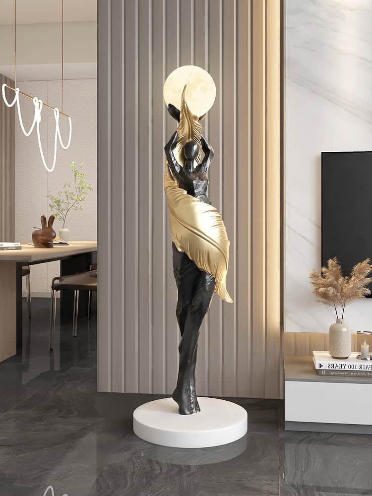 Elegant gold and black human figurine sculpture holding a moon, stylish decor for Monalisa Medical store, ideal for modern interior design, decorative art piece enhancing space aesthetics.